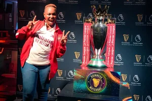 Arsenal fan Carol Radull with the Premier League trophy in Nairobi