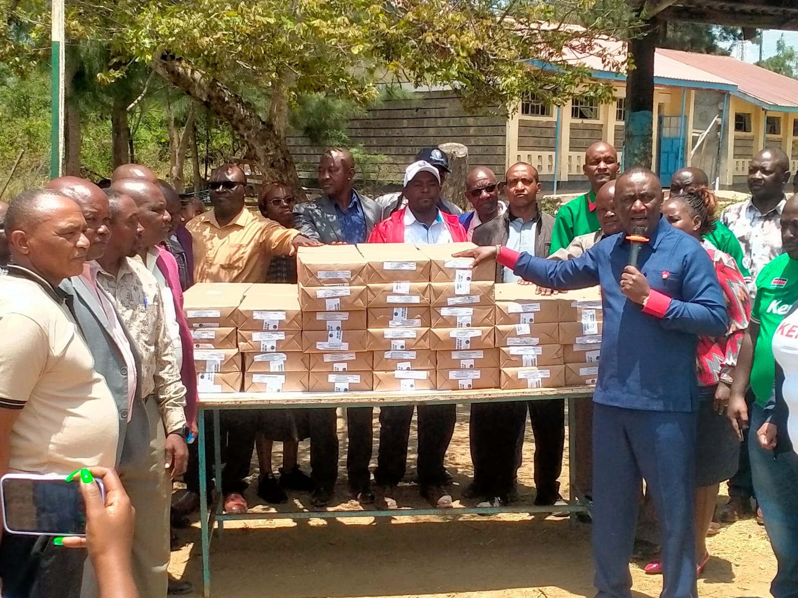 Matungulu MP Stephen Mule addresses teachers while holding revision textbooks worth KES 5 million, provided for students to use ahead of their final KPSEA and KCSE exams, during a ceremony held at Tala High School grounds on Friday, September 25, 2026. 
