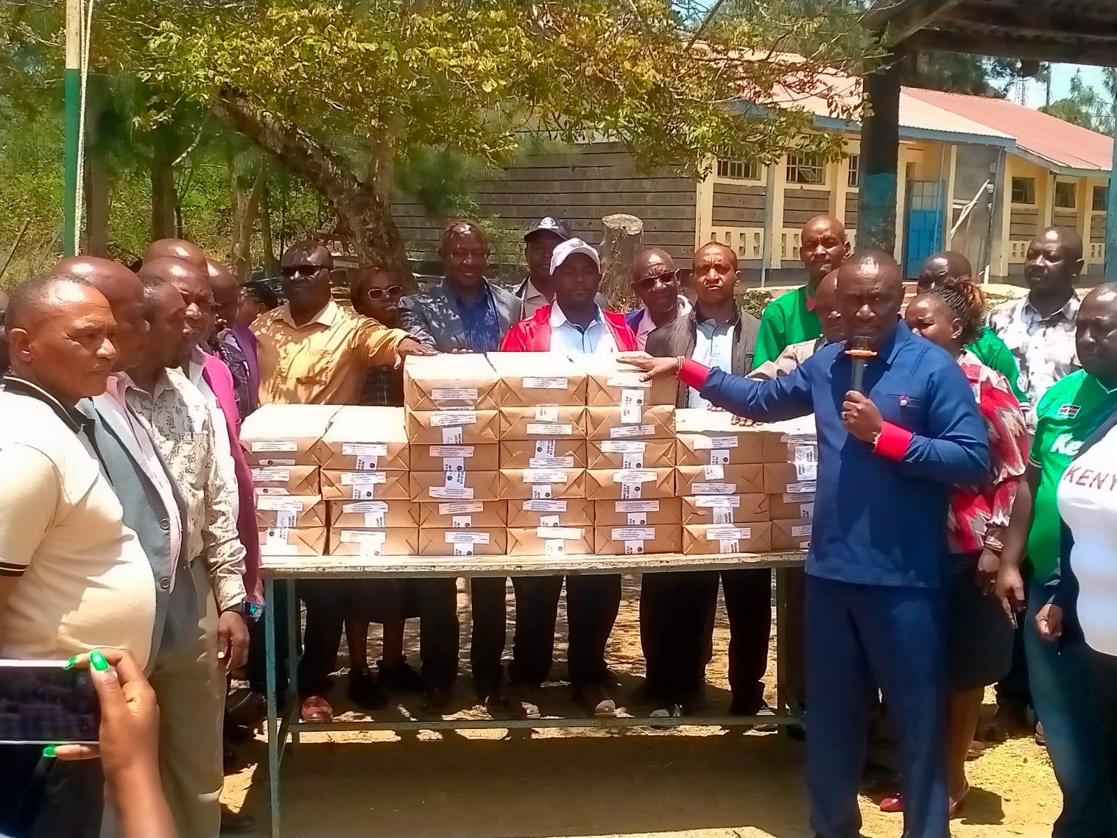 Matungulu MP Stephen Mule addresses teachers while holding revision textbooks worth KES 5 million, provided for students to use ahead of their final KPSEA and KCSE exams, during a ceremony held at Tala High School grounds on Friday, September 25, 2026. 